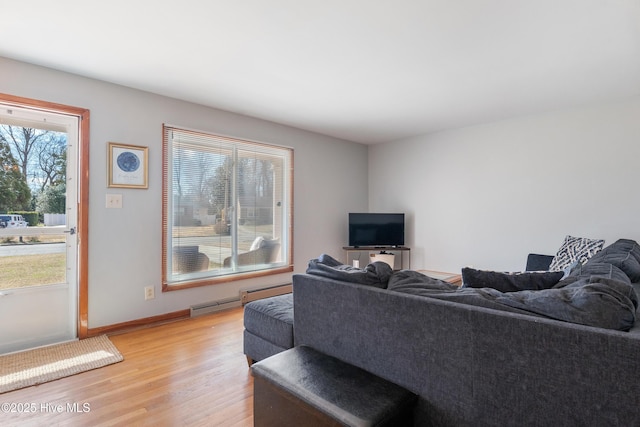 living area featuring light wood-style flooring and baseboards