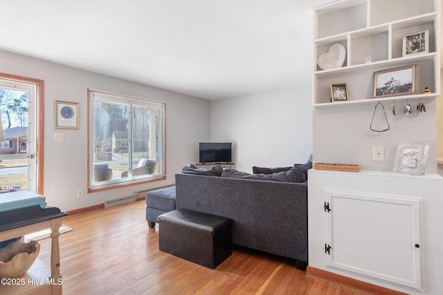 living area with light wood-style floors and baseboards