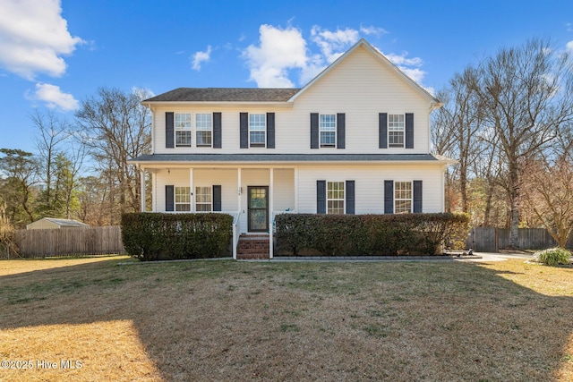 view of front of property with a front yard, covered porch, and fence