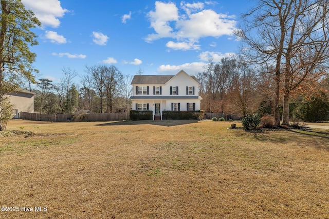 view of front of house featuring covered porch, fence, and a front yard