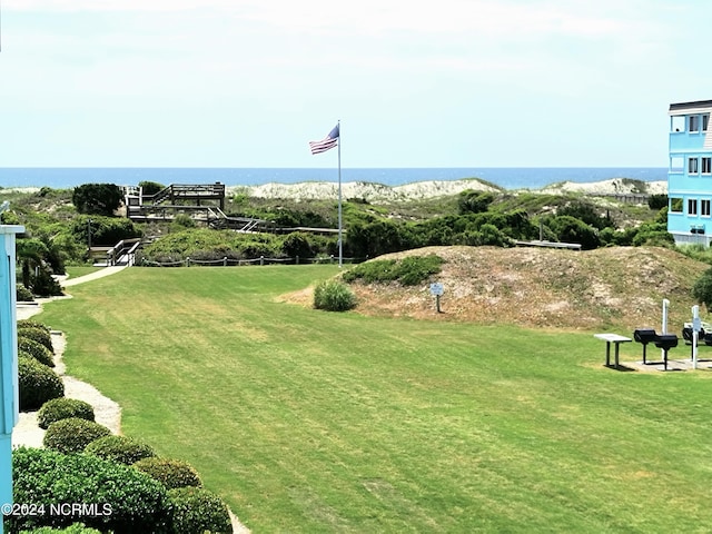 exterior space with a lawn and a water view