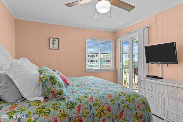 bedroom with a textured ceiling, ceiling fan, ornamental molding, and access to exterior