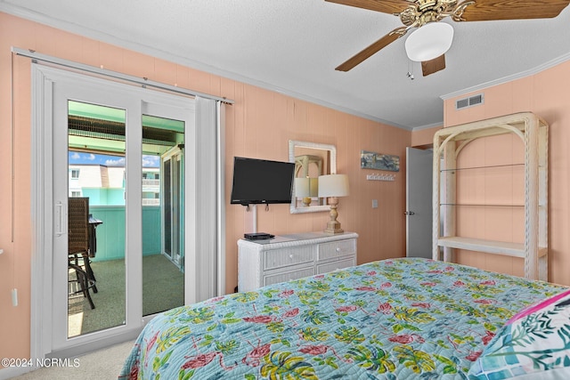 carpeted bedroom with crown molding, visible vents, ceiling fan, a textured ceiling, and access to outside