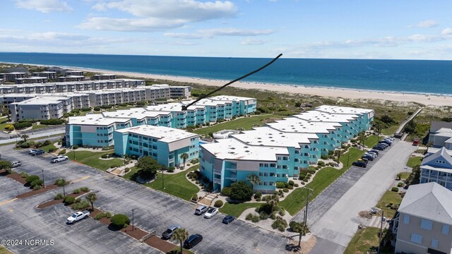 drone / aerial view with a water view and a beach view