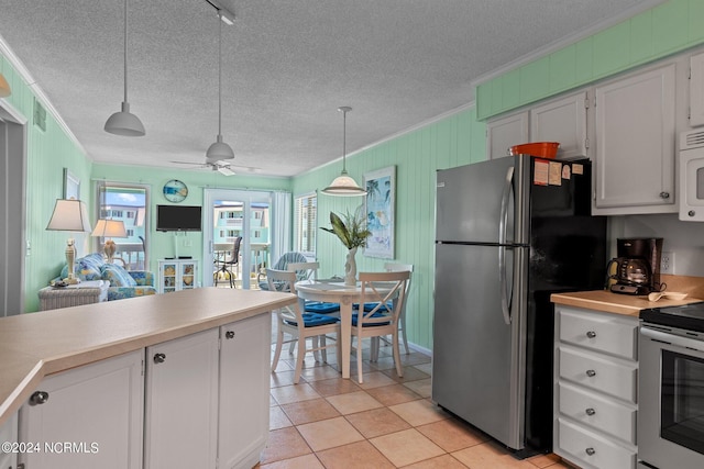 kitchen with light countertops, appliances with stainless steel finishes, white cabinetry, and crown molding