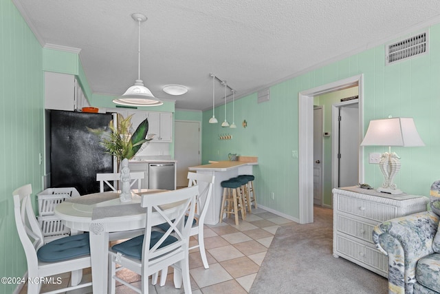 dining area with visible vents, crown molding, a textured ceiling, and light tile patterned floors