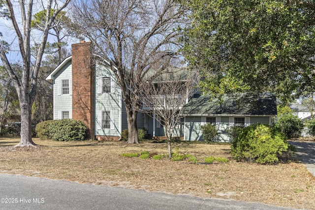 view of front facade with a chimney