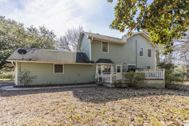 rear view of property with a wooden deck