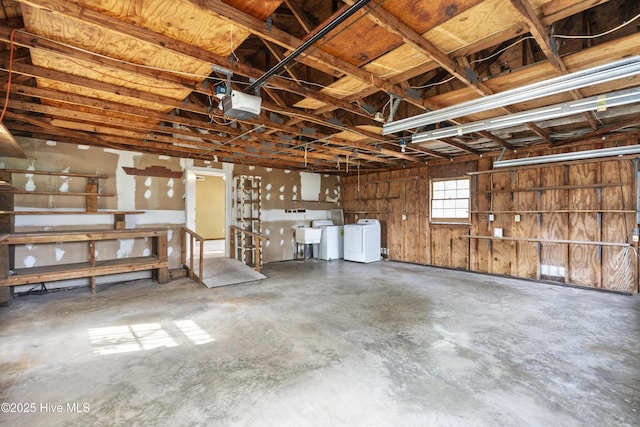 garage with washer / dryer, a sink, and a garage door opener