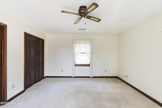 unfurnished room featuring light carpet, visible vents, and baseboards