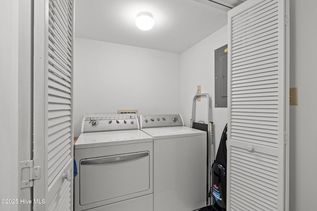 washroom featuring laundry area, washing machine and clothes dryer, and electric panel