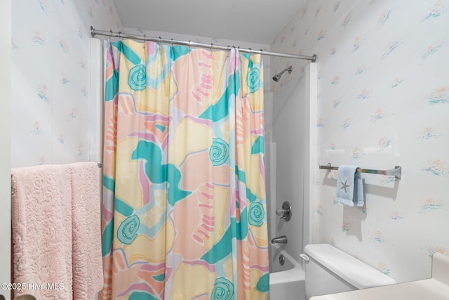 full bath featuring toilet, wallpapered walls, and shower / bath combo with shower curtain