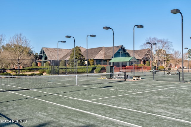 view of tennis court featuring fence