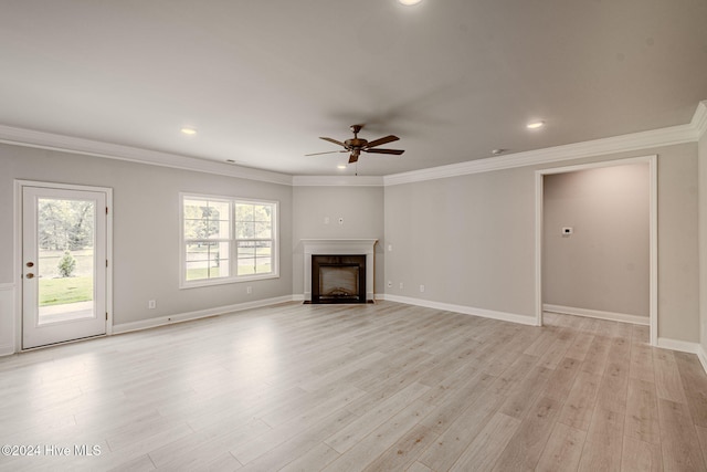 unfurnished living room with a fireplace with flush hearth, crown molding, light wood-style flooring, and baseboards