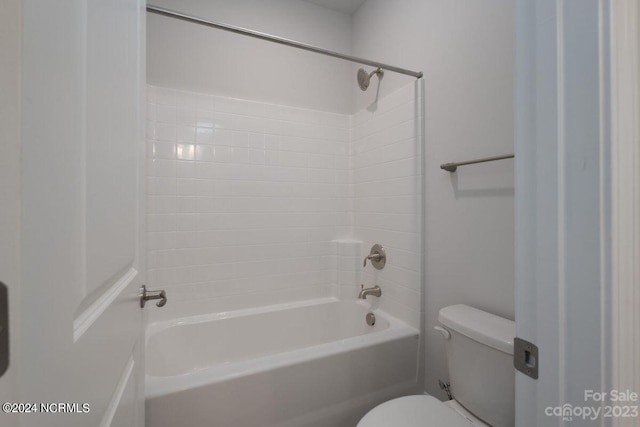 bathroom featuring bathtub / shower combination and toilet