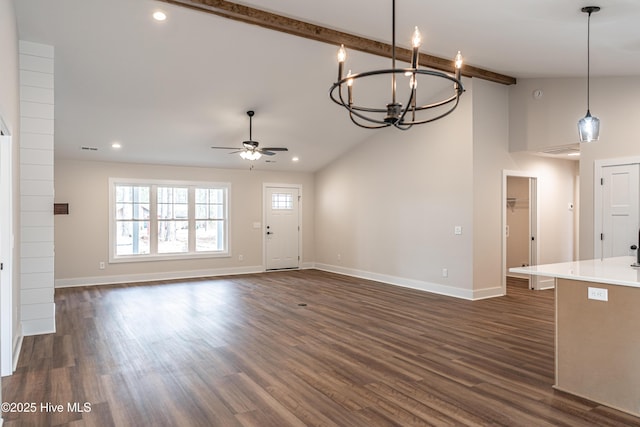 unfurnished living room with ceiling fan with notable chandelier, baseboards, dark wood-style flooring, and beamed ceiling