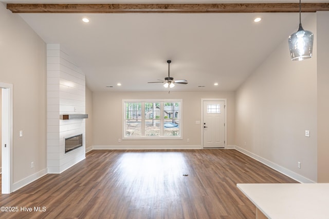 unfurnished living room with dark wood-style floors, a fireplace, baseboards, and recessed lighting