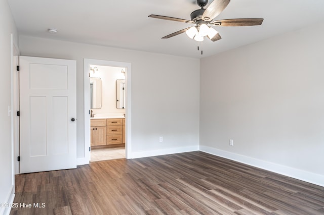 unfurnished bedroom with a ceiling fan, connected bathroom, baseboards, and wood finished floors