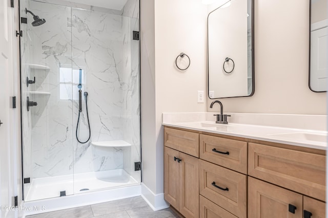 bathroom featuring double vanity, a marble finish shower, and a sink