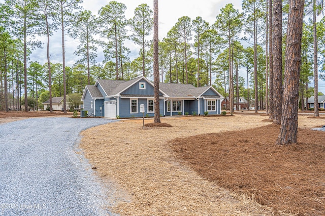 view of front of property featuring a garage, driveway, and board and batten siding