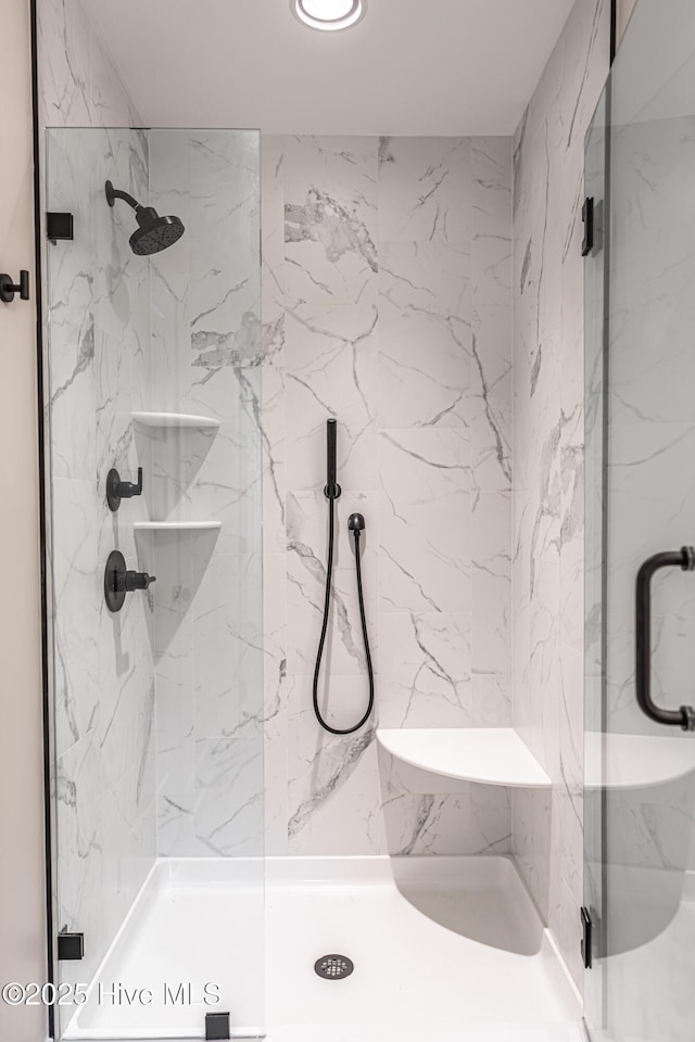 bathroom with a marble finish shower