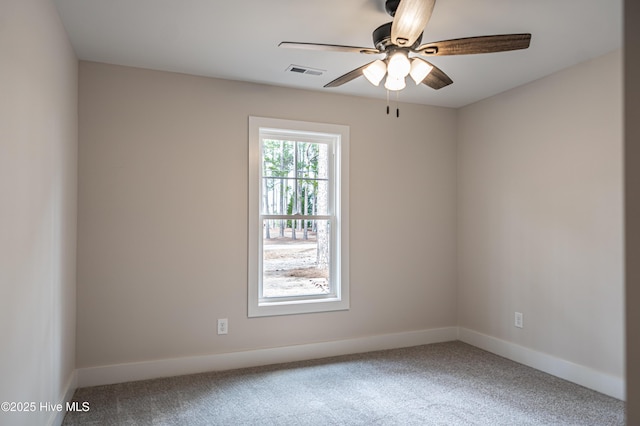 unfurnished room featuring carpet floors, baseboards, visible vents, and ceiling fan