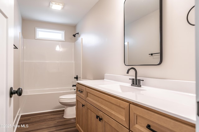 full bath featuring shower / bathtub combination, vanity, wood finished floors, and toilet