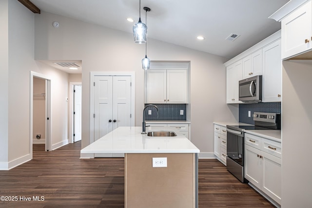 kitchen with lofted ceiling, dark wood-type flooring, a sink, visible vents, and appliances with stainless steel finishes