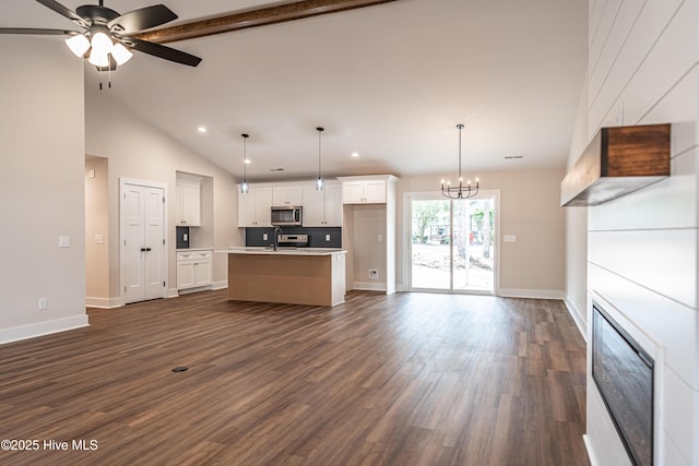 kitchen featuring white cabinetry, stainless steel appliances, dark wood finished floors, and open floor plan