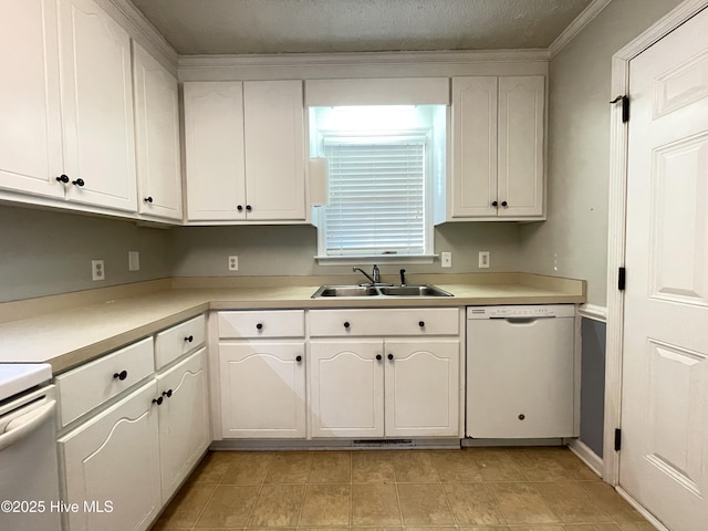 kitchen with light countertops, white cabinets, a sink, a textured ceiling, and white appliances