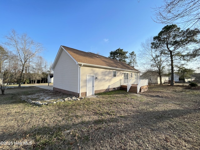 view of home's exterior with a wooden deck