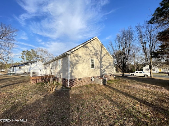 view of home's exterior with a yard, crawl space, and a wooden deck