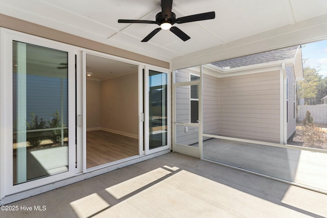 unfurnished sunroom featuring a ceiling fan