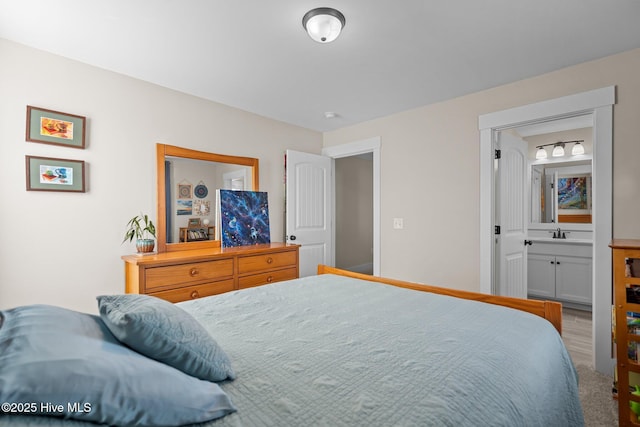 bedroom with ensuite bath and a sink