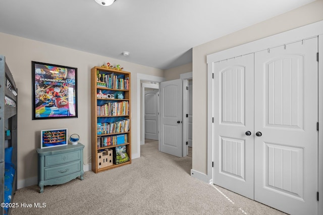 interior space with baseboards, a closet, and carpet flooring