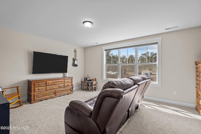 living room featuring carpet floors, visible vents, and baseboards