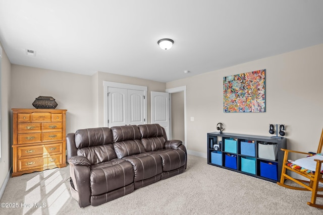 living area with carpet flooring, visible vents, and baseboards