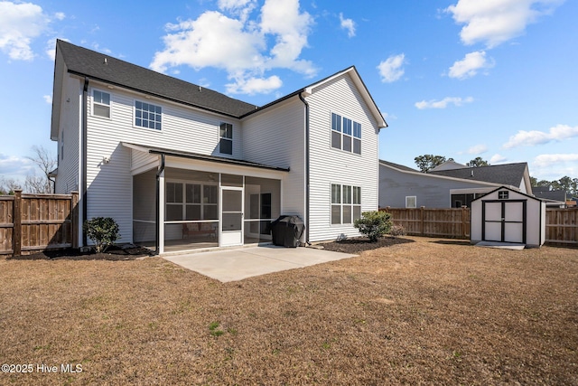 back of house with a yard, a storage unit, a sunroom, a patio area, and a fenced backyard