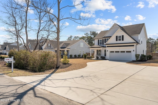 view of front of home with a garage, a residential view, and concrete driveway