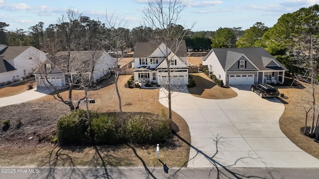 view of front facade with a residential view and concrete driveway