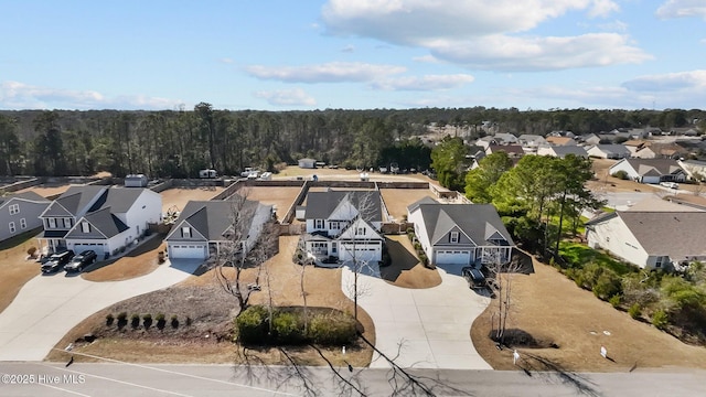 birds eye view of property with a residential view and a wooded view