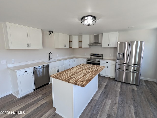 kitchen featuring dark wood-style flooring, open shelves, stainless steel appliances, a sink, and wall chimney exhaust hood