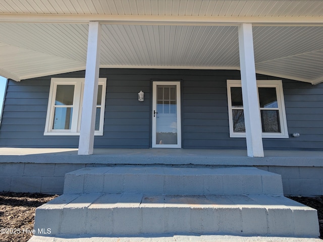 view of exterior entry with covered porch