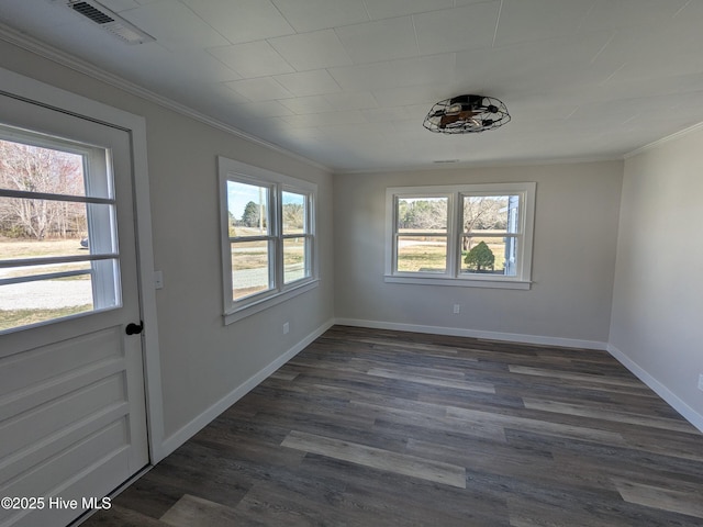 interior space featuring ornamental molding, visible vents, baseboards, and dark wood-style floors