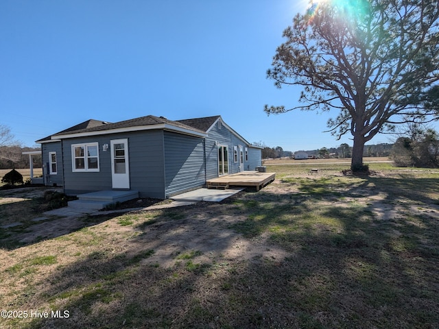 exterior space featuring a deck and a lawn