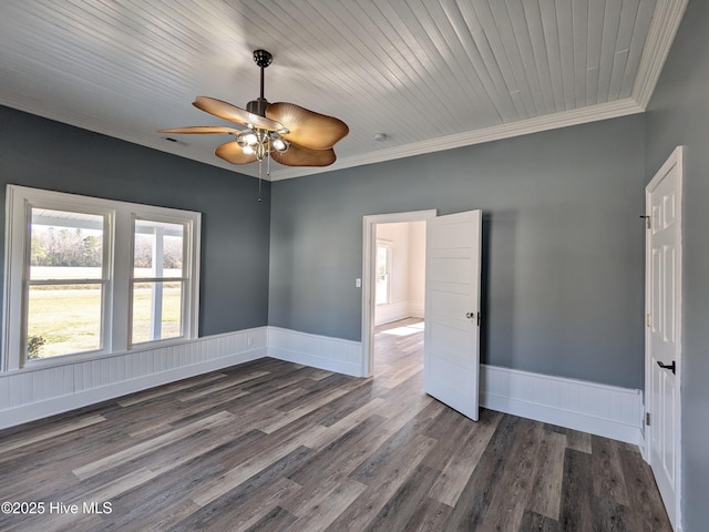 unfurnished room with a ceiling fan, baseboards, crown molding, and wood finished floors