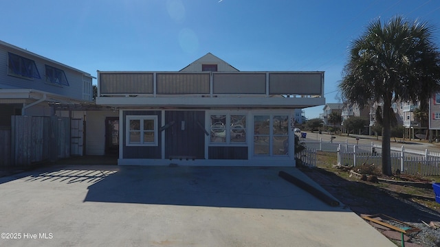 exterior space with fence and a balcony