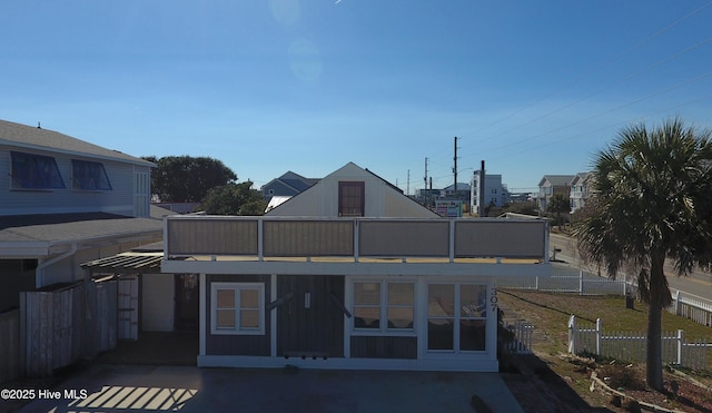 rear view of property with fence and a patio