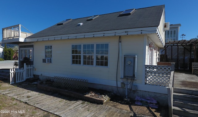 view of side of property with a shingled roof