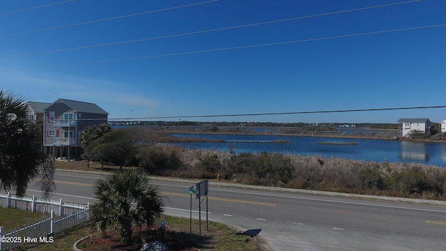 property view of water featuring fence